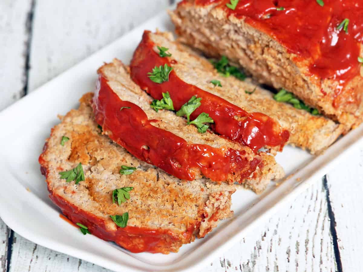 A sliced turkey meatloaf on a serving tray.