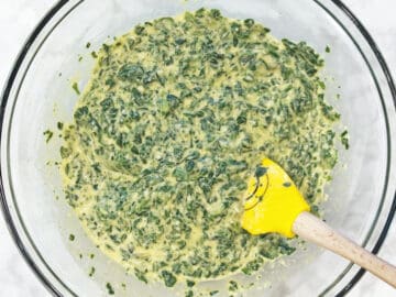 Mixing in spinach and parmesan.