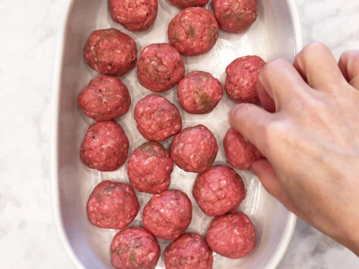 Arranging the meatballs in the pan.