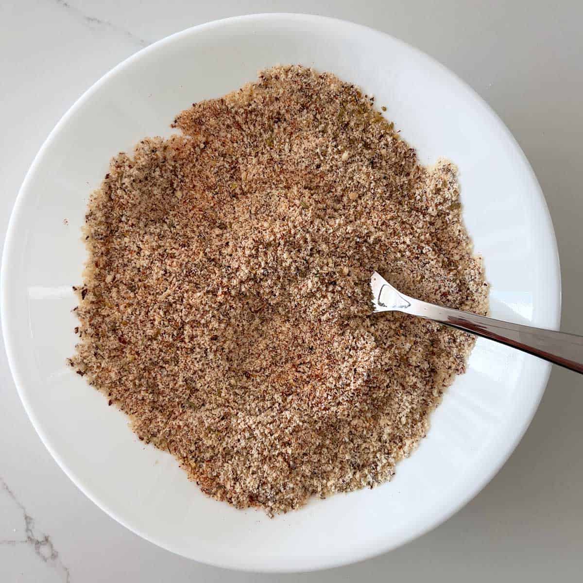 Almond meal and spices are mixed in a bowl.