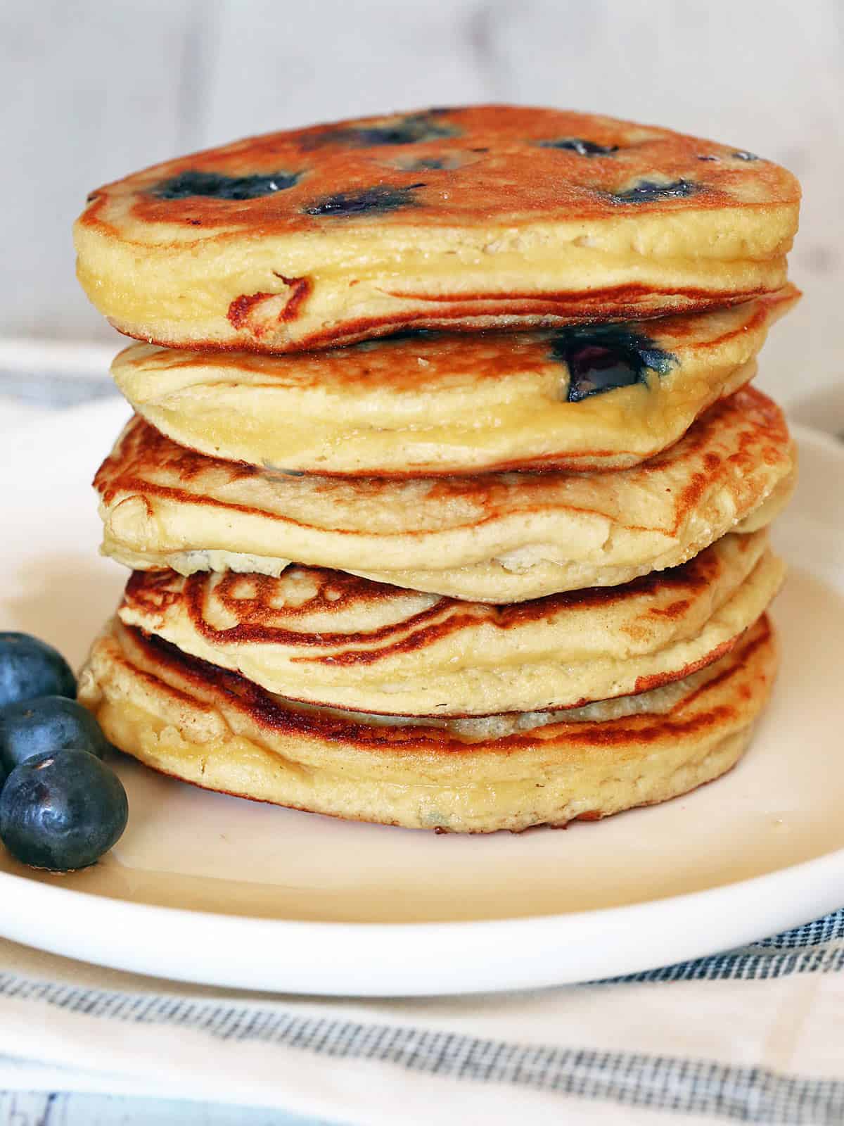 Coconut flour pancakes are served on a white plate.