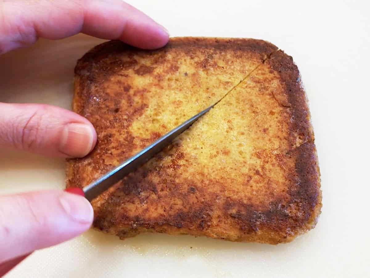 Cutting the toast in half.