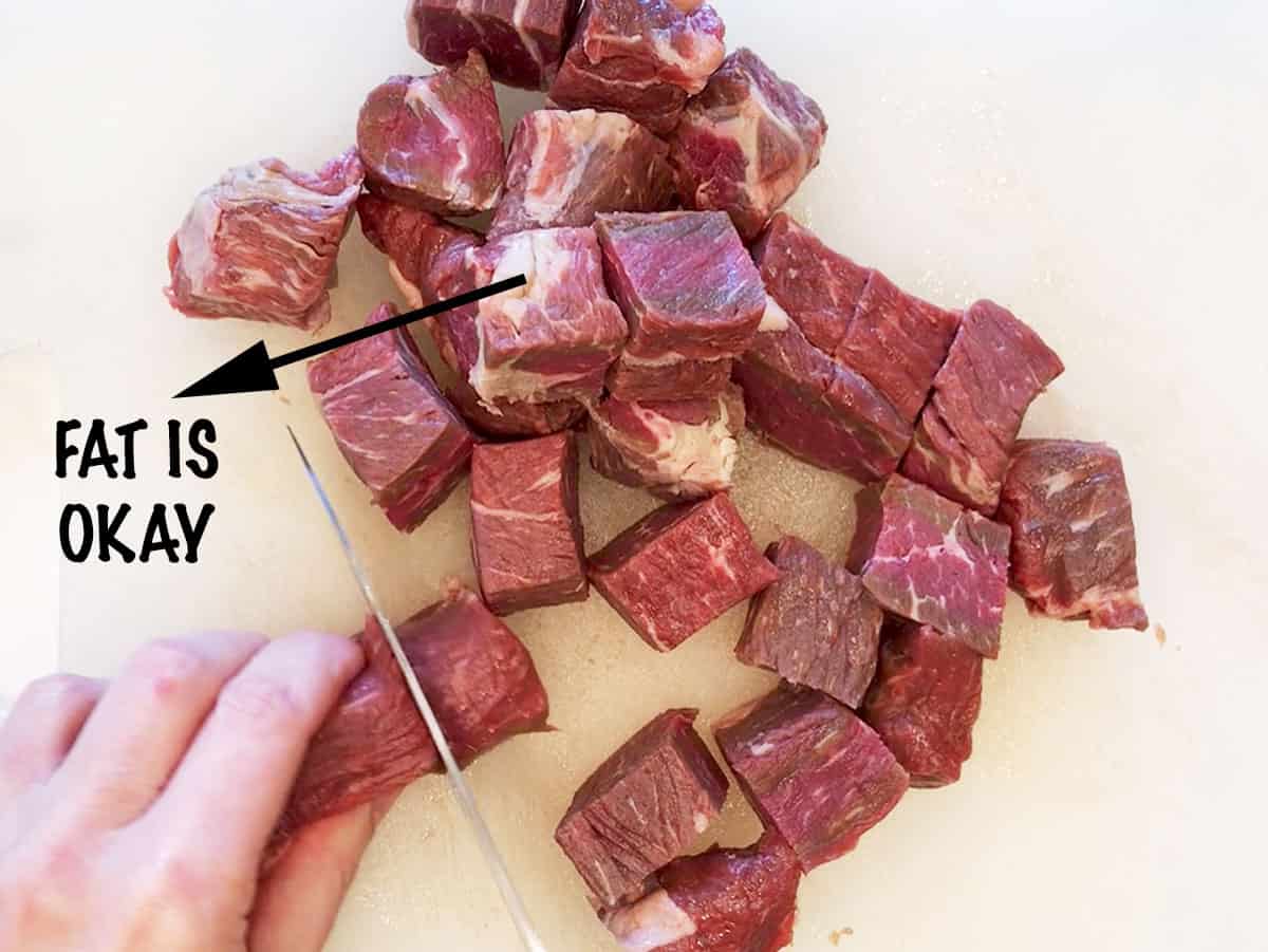 It's OK to leave some of the fat on when cubing the steak.