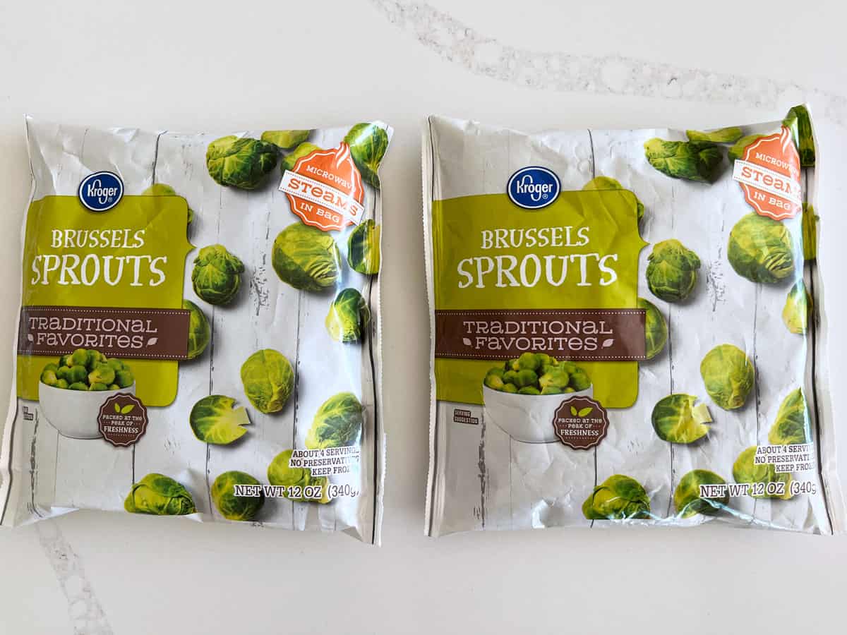 Two packages of frozen Brussels sprouts.
