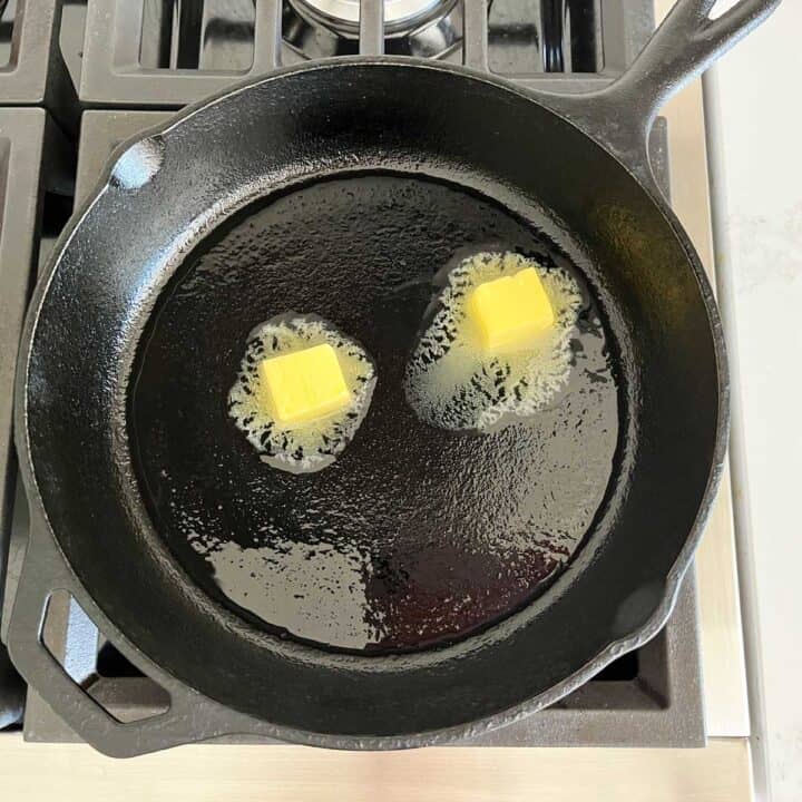 Melting butter in a cast-iron skillet.