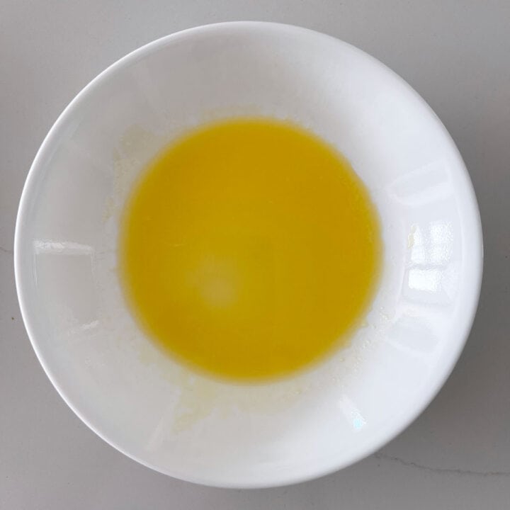 Melted butter in a white bowl.