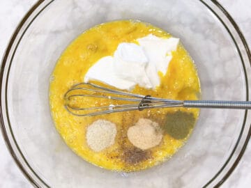Mixing eggs, sour cream, and spices.