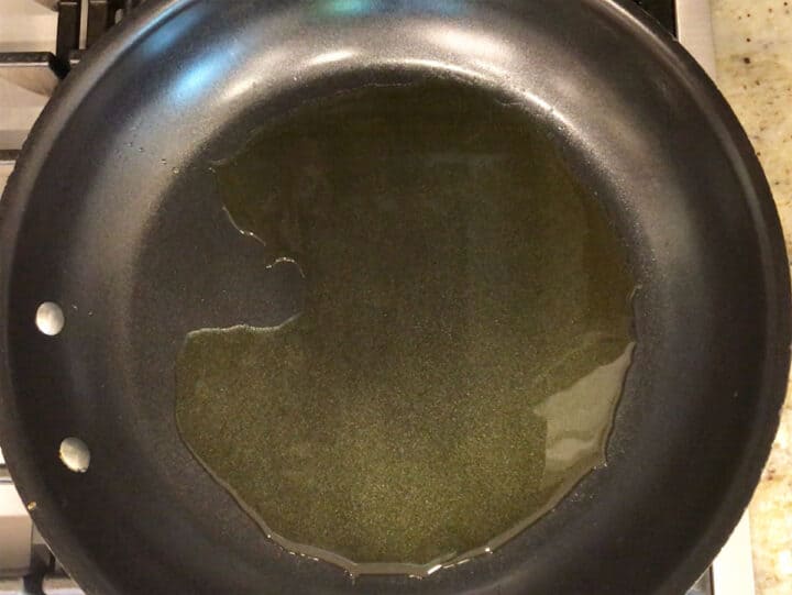 Heating oil in a nonstick skillet.