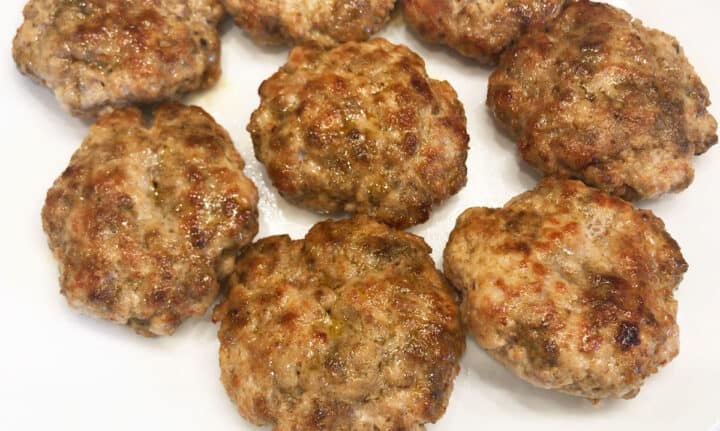 The sausage patties are ready on a plate.