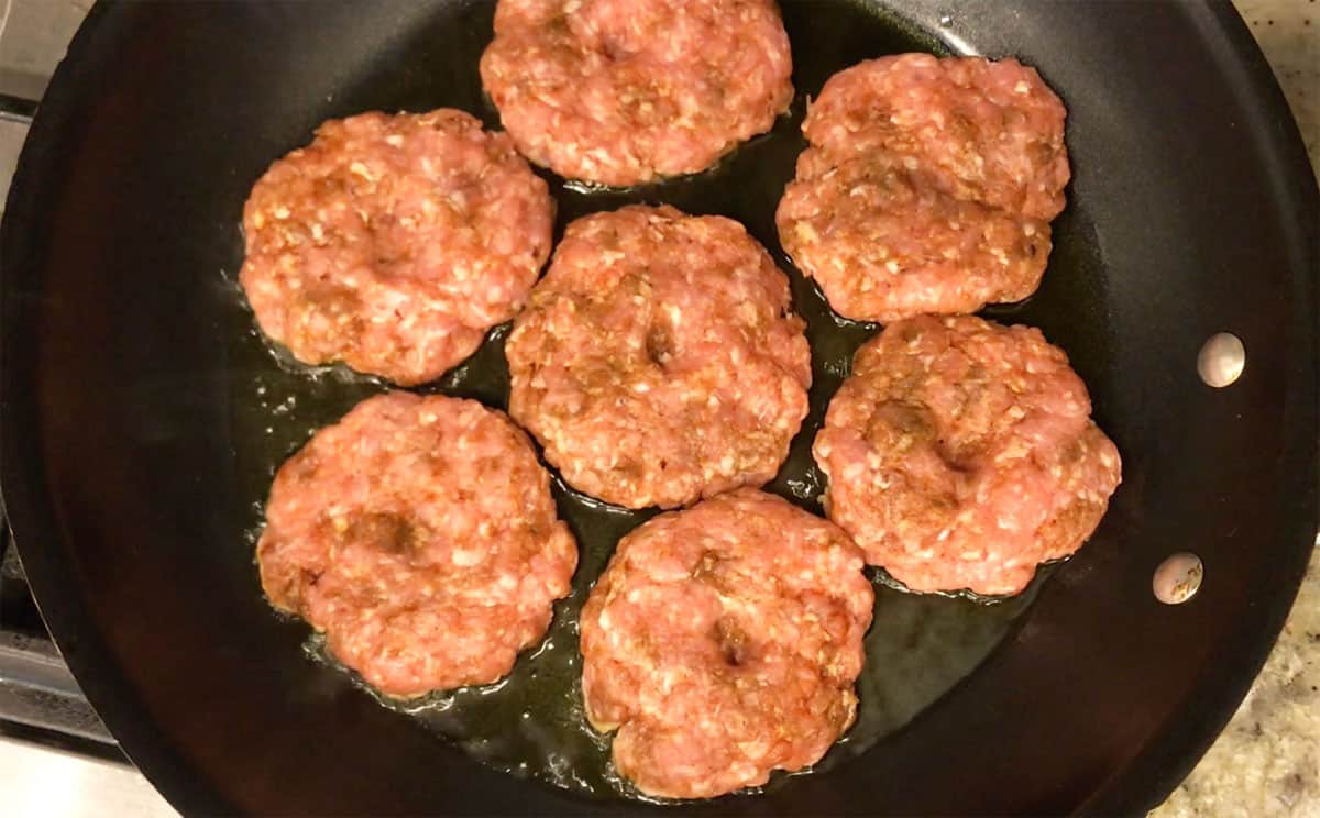 The sausage patties at the start of cooking.