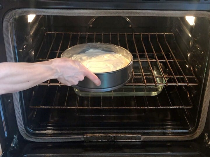 Placing the cake in the oven.