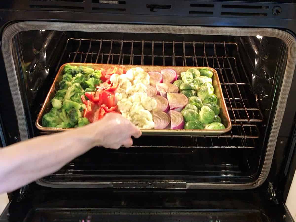 Placing the vegetables in the oven.