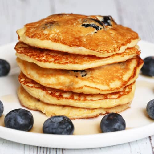 A stack of protein pancakes garnished with blueberries.