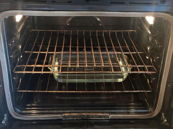 A Pyrex dish with water is placed on the oven's bottom rack.