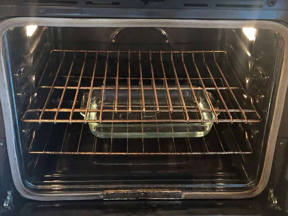 A Pyrex dish with water is placed on the oven's bottom rack.
