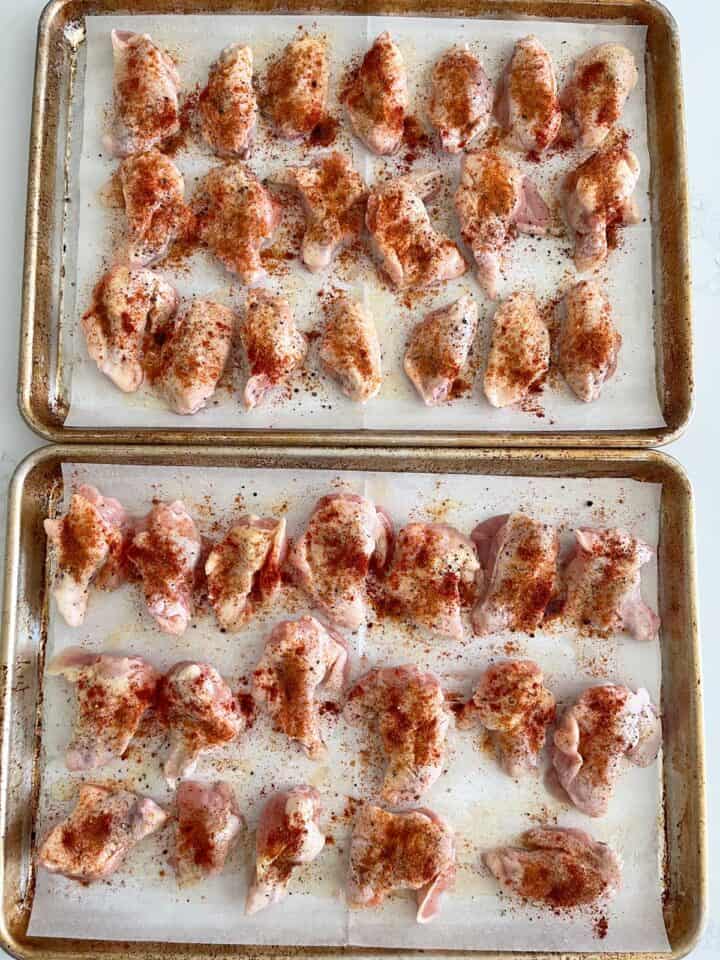 The raw chicken wings are seasoned and ready for the oven.