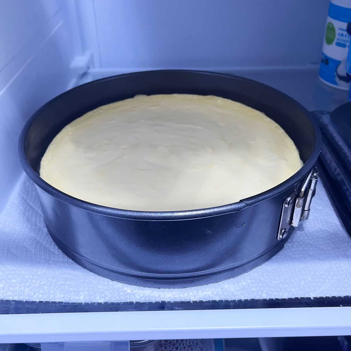 Refrigerating the cheesecake until set.