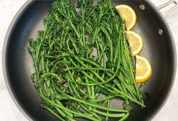 Serving the broccolini with lemon slices.