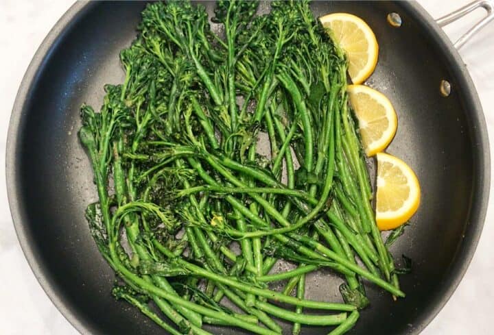 Serving the broccolini with lemon slices.