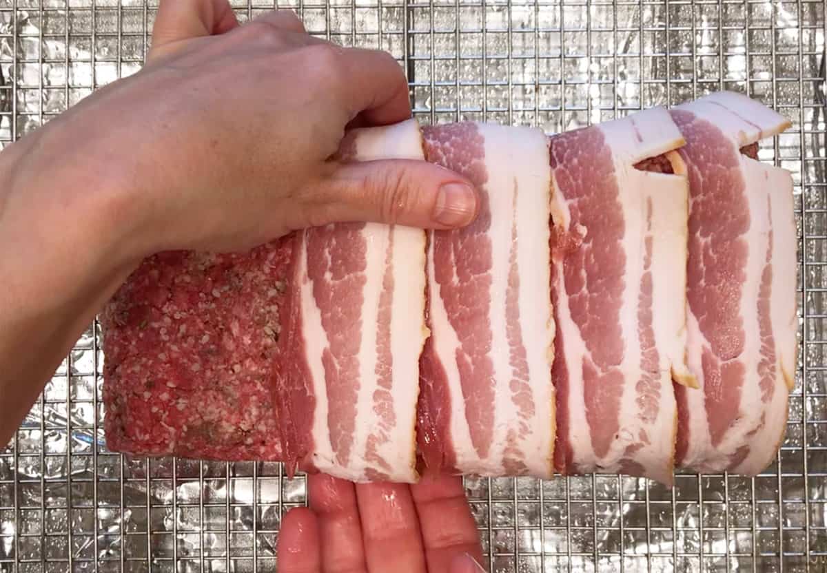 Wrapping the meatloaf in bacon.
