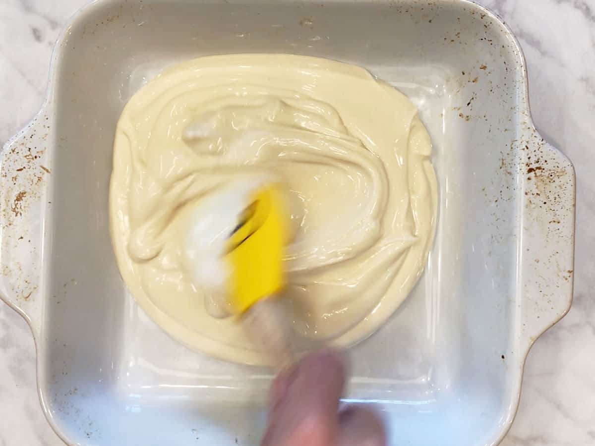 Spreading the yogurt in the pan.
