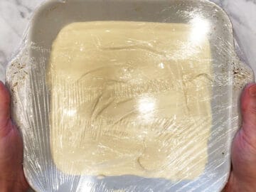 Wrapping the pan in cling wrap.
