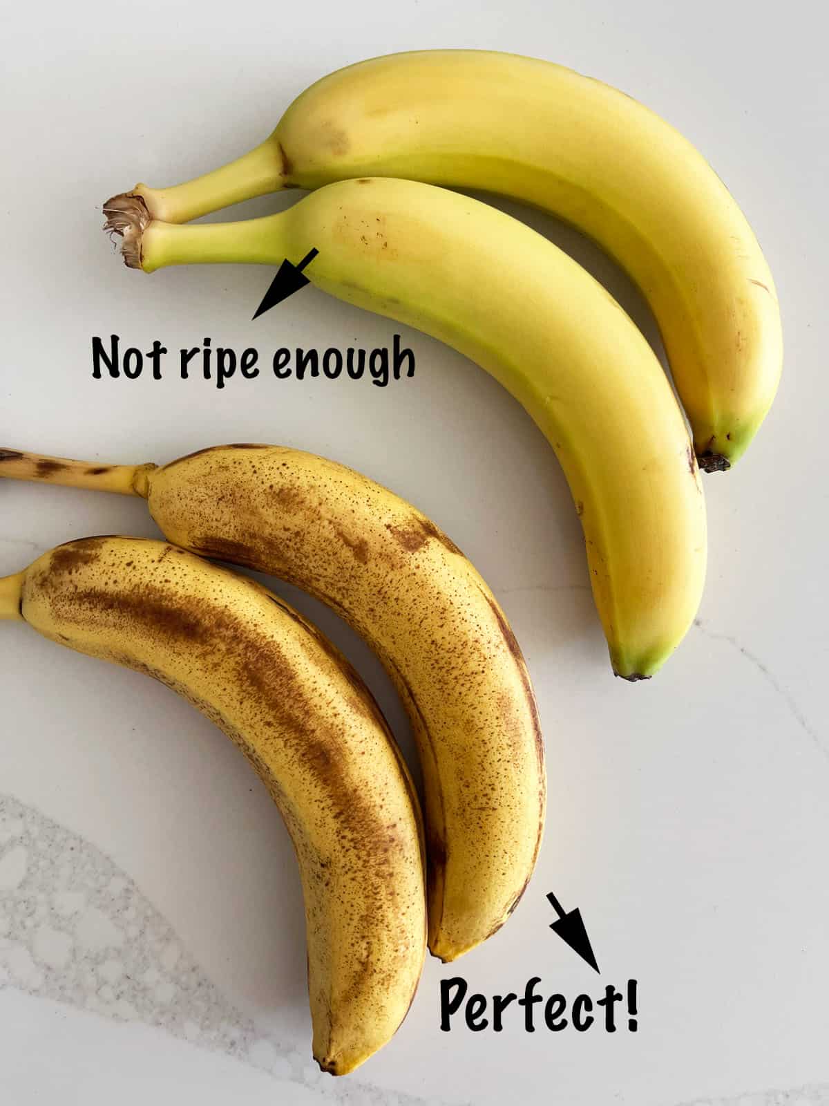 Two bananas that are not ripe enough for banana bread and two that are just right.