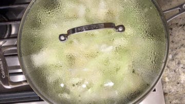 The cabbage is steaming in the covered skillet.