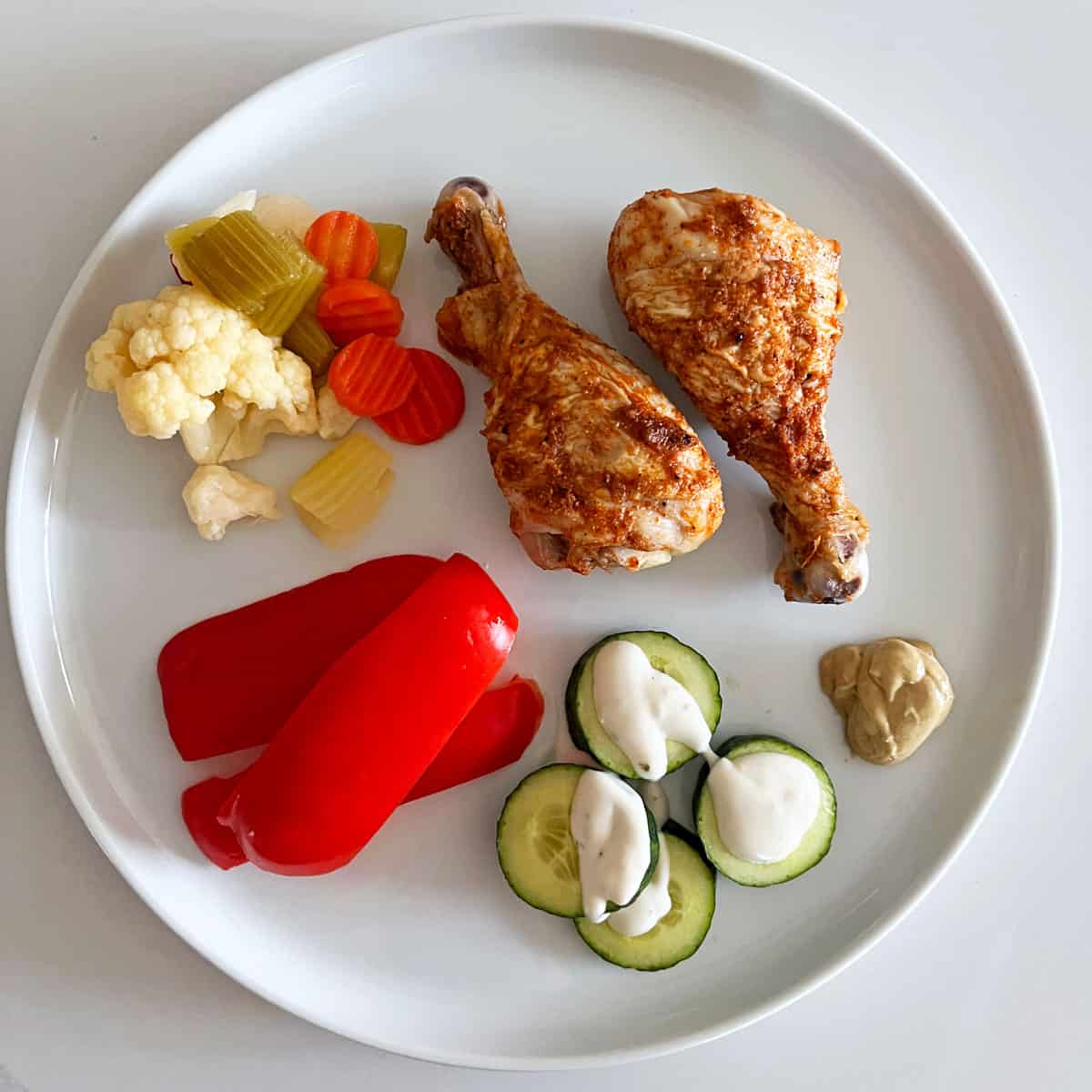 Drumstick leftovers are served with veggies and pickles.