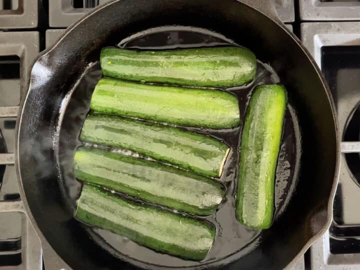 Cooking the zucchini in the skillet.