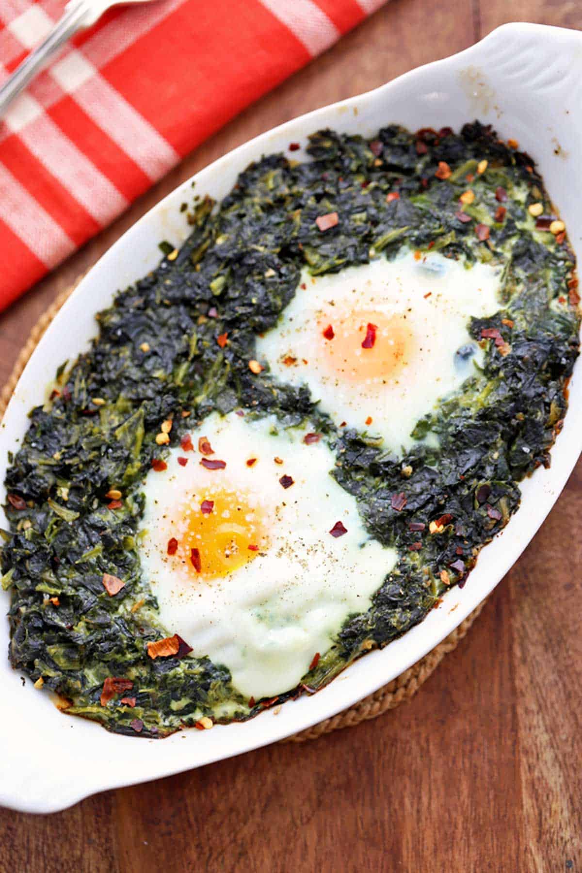 Two eggs baked on top of creamed spinach.