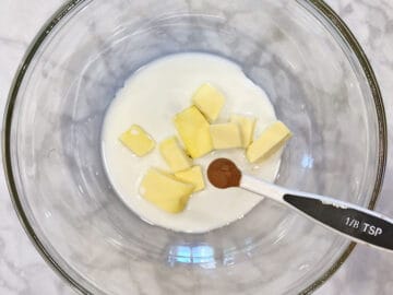 Adding the creamy ingredients to a bowl.