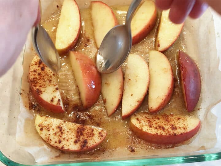 Flipping the apples in the pan.