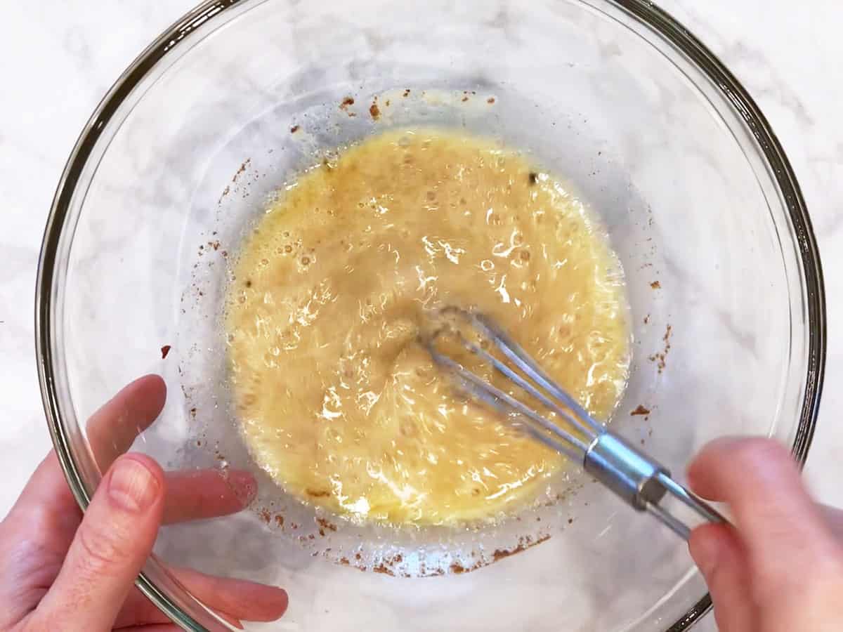 Mixing the melted creamy ingredients in a bowl.