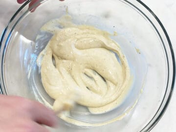 Mixing the salad dressing in a bowl.