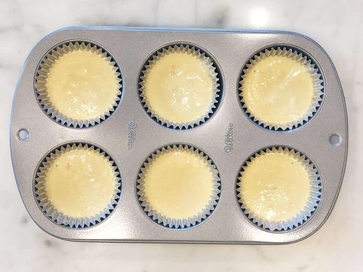 The muffin batter was divided between the muffin liners.