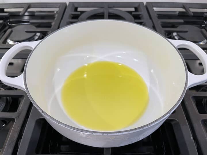 Heating olive oil in a saucepan.