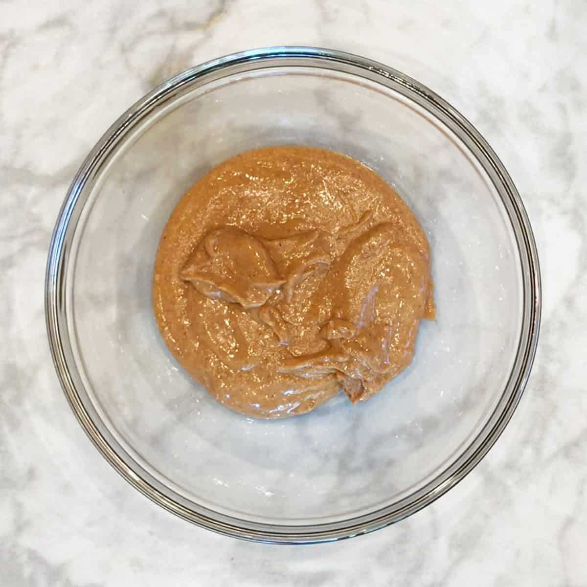 Peanut butter in a bowl, showing its texture.
