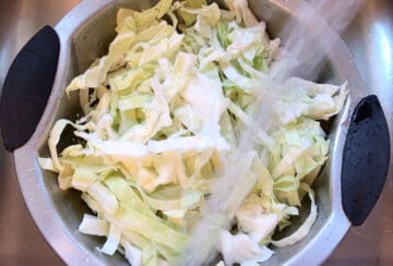 Rinsing the shredded cabbage.