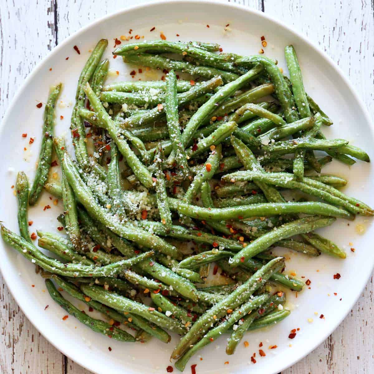 Roasted green beans are topped with parmesan.