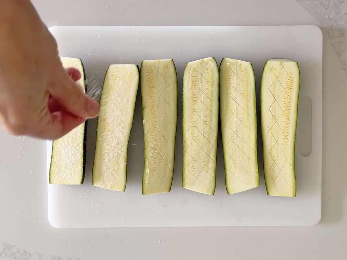 Salting the zucchini.