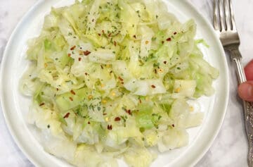 The cabbage is served on a white plate.
