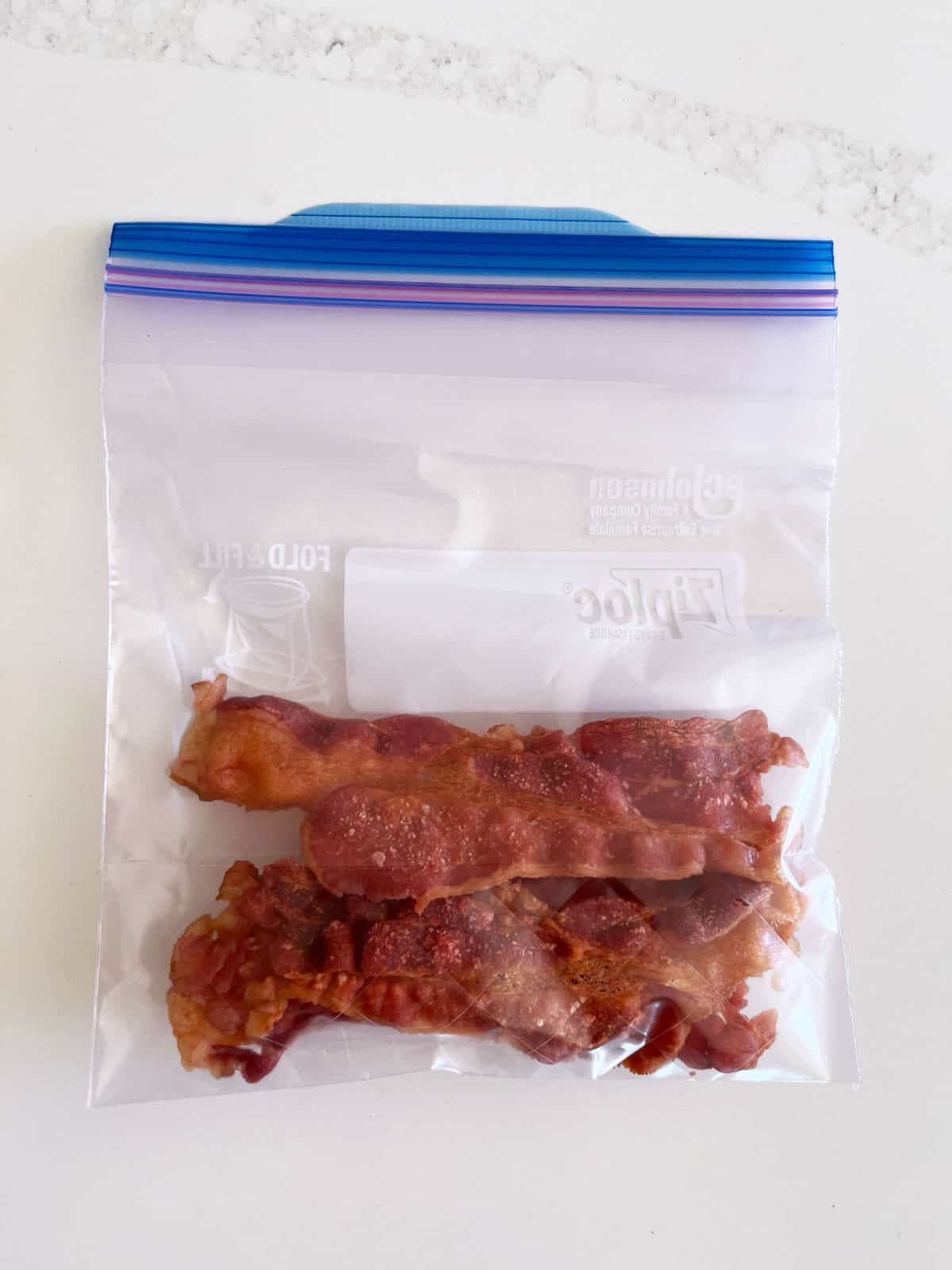Leftover bacon is stored in a resealable bag.