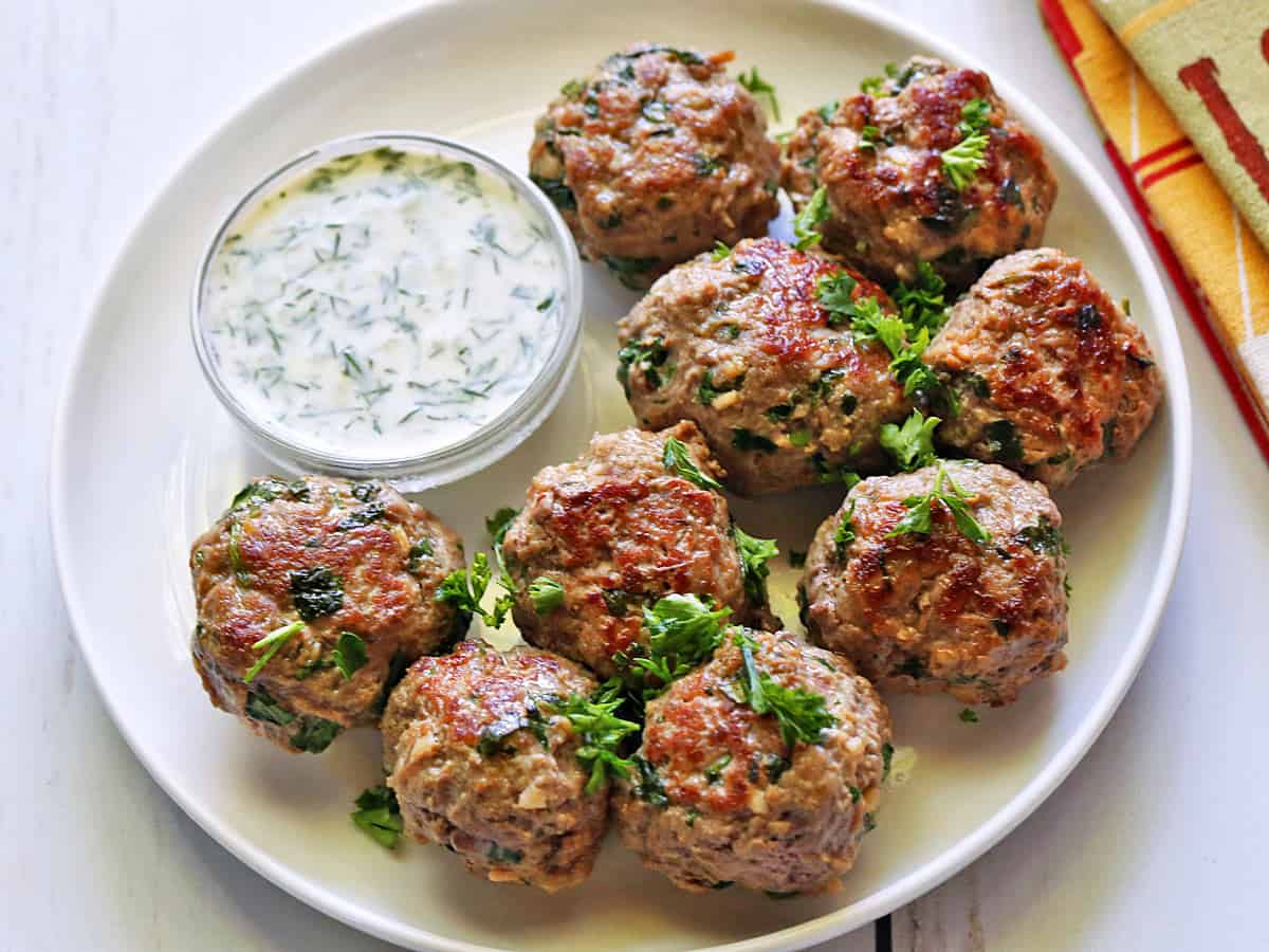 Lamb meatballs are served with a yogurt dip.