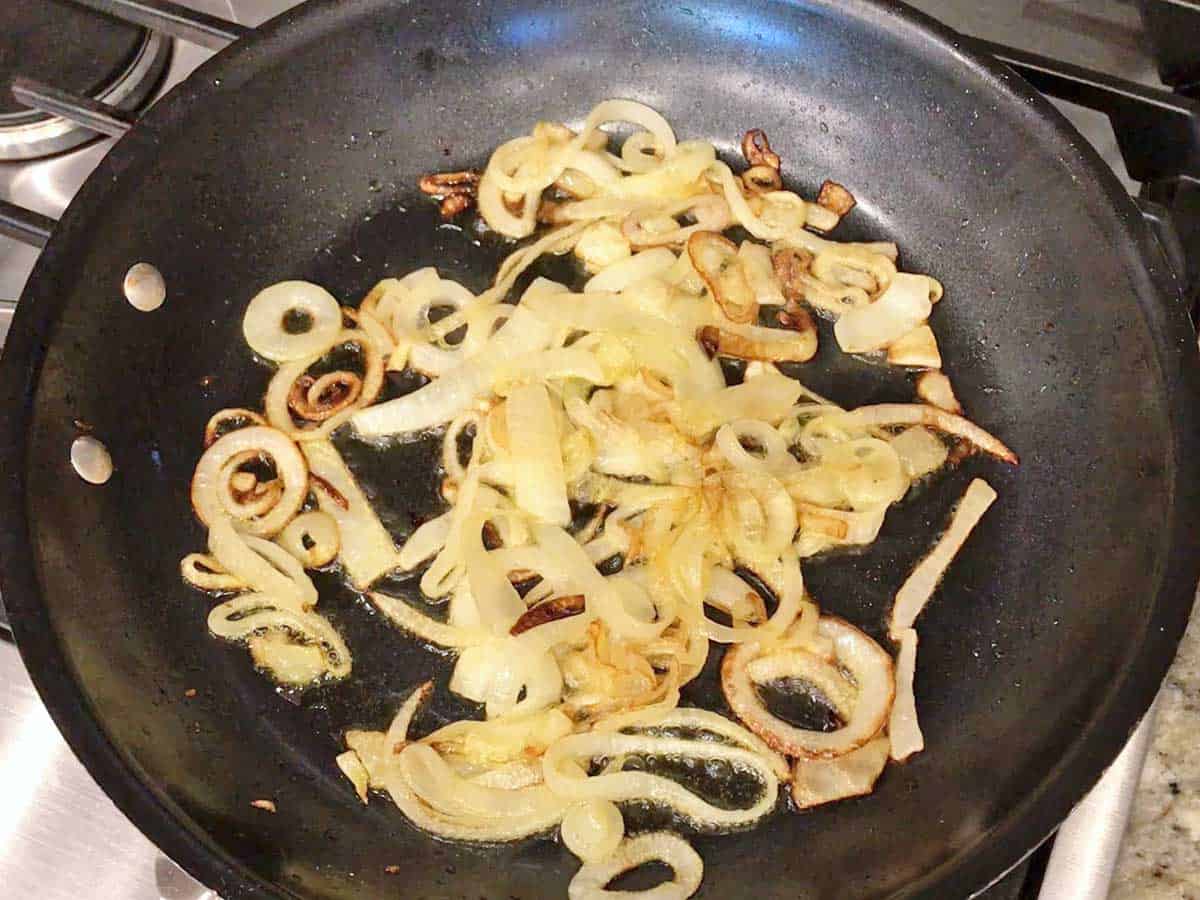 Cooking the onions in a skillet.