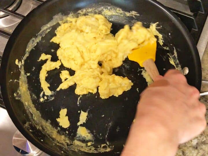 Cooking the eggs in the skillet.