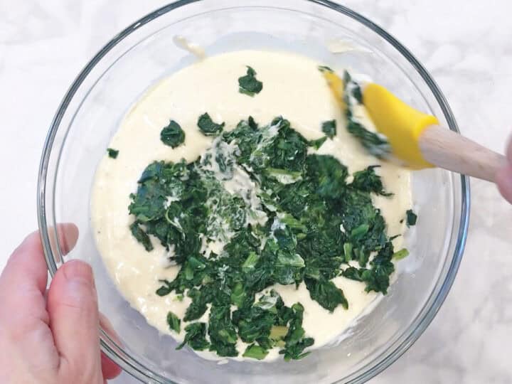 Mixing cream cheese and spinach.