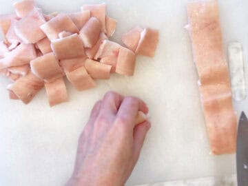 Cutting pork skin into squares.