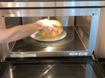 Placing the squash in the microwave.