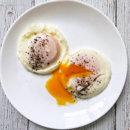 Two poached eggs on a plate.